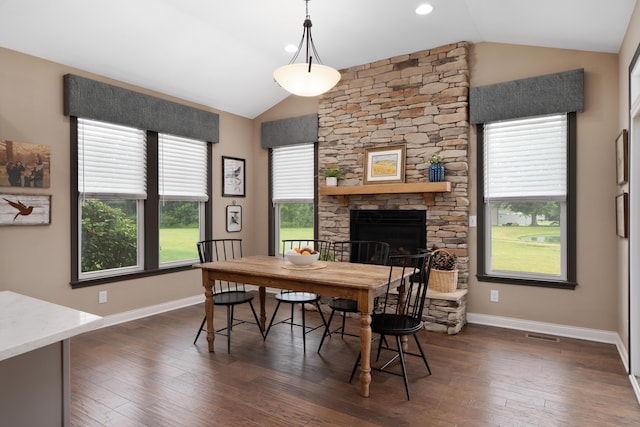6196 Streamside Dr, Galena, OH 43021 - dining room featuring vaulted ceiling, dark wood-type flooring, and a stone fireplace