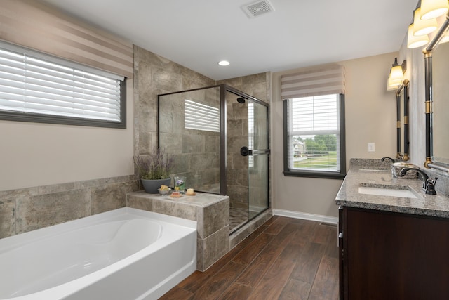 6196 Streamside Dr, Galena, OH 43021 - bathroom featuring a garden tub, double vanity, a shower stall, wood finished floors, and recessed lighting