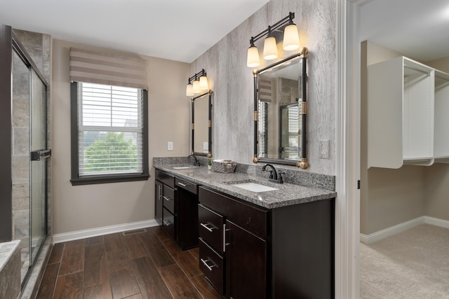 6196 Streamside Dr, Galena, OH 43021 - bathroom with double vanity, wood finished floors, a shower with shower door, and a spacious closet