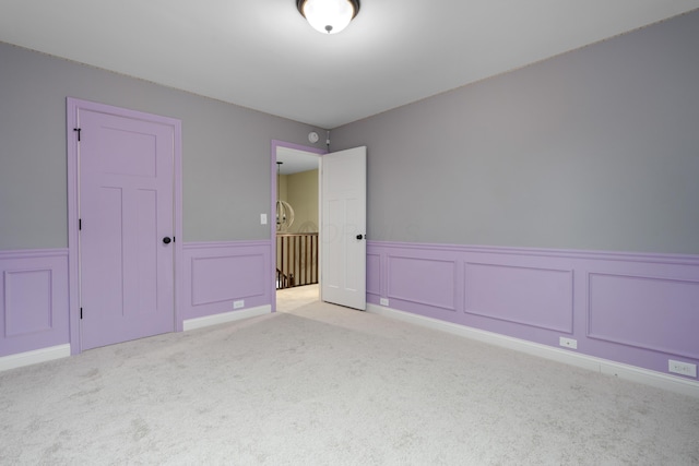 6196 Streamside Dr, Galena, OH 43021 - unfurnished bedroom with light colored carpet, wainscoting, and a decorative wall
