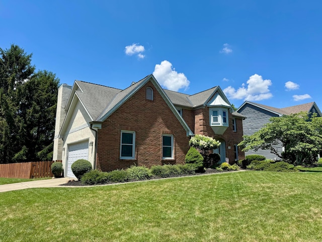 305 Sterling Ct, Westerville, OH 43082 - traditional-style house featuring an attached garage, a chimney, driveway, and brick siding