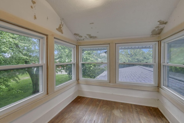 6135 Westfall Rd SW, Lancaster, OH 43130 - unfurnished sunroom with vaulted ceiling, wood-type flooring, and a textured ceiling