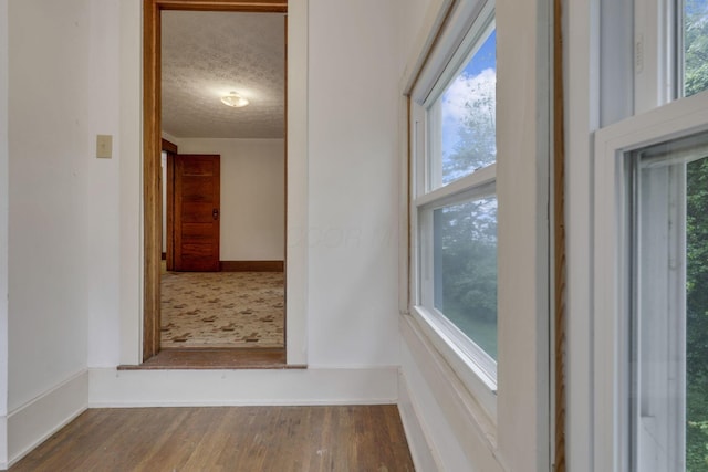 6135 Westfall Rd SW, Lancaster, OH 43130 - hall featuring wood finished floors, a textured ceiling, and plenty of natural light
