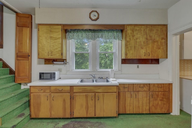 6135 Westfall Rd SW, Lancaster, OH 43130 - kitchen with light countertops, brown cabinets, and light colored carpet