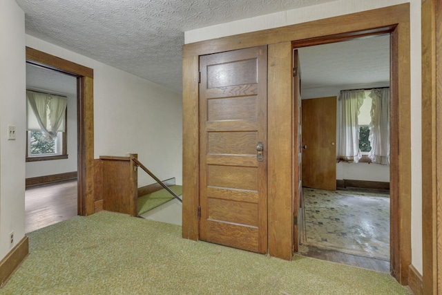 6135 Westfall Rd SW, Lancaster, OH 43130 - hall with an upstairs landing, healthy amount of natural light, carpet, and a textured ceiling