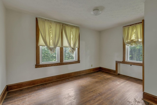 6135 Westfall Rd SW, Lancaster, OH 43130 - empty room featuring wood finished floors and a textured ceiling