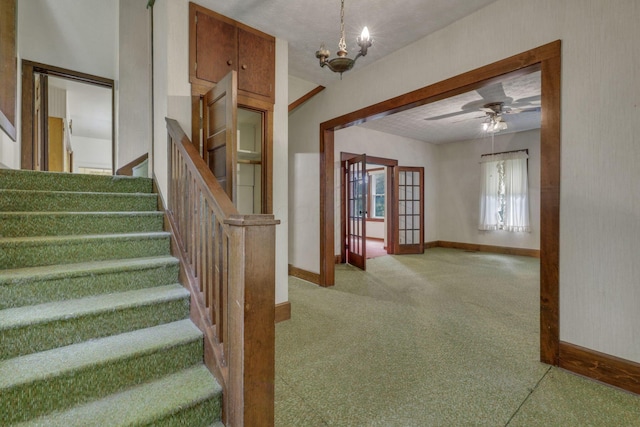 6135 Westfall Rd SW, Lancaster, OH 43130 - stairway with carpet floors, a chandelier, and a ceiling fan