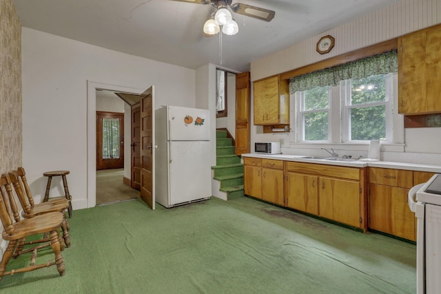 6135 Westfall Rd SW, Lancaster, OH 43130 - kitchen featuring freestanding refrigerator, light colored carpet, light countertops, range, and a ceiling fan