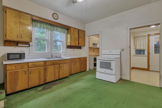 6135 Westfall Rd SW, Lancaster, OH 43130 - kitchen with electric stove, black microwave, light countertops, and brown cabinetry
