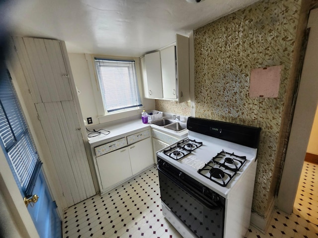 1058 Fair Ave, Columbus, OH 43205 - kitchen featuring white gas range oven, white cabinets, light floors, and light countertops