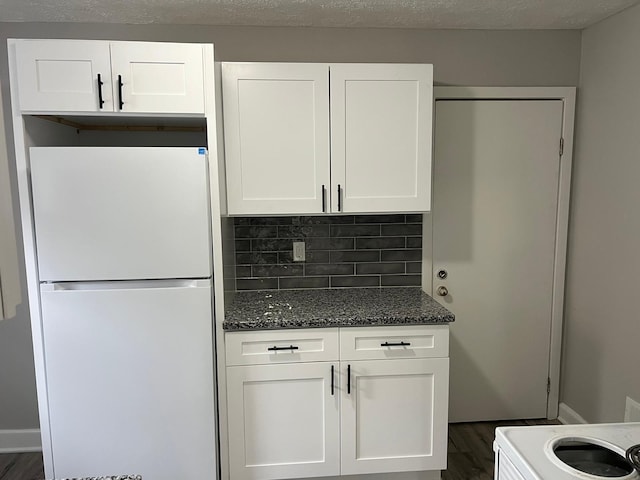 1116-1122 Cole St, Columbus, OH 43205 - kitchen with freestanding refrigerator, dark wood finished floors, white cabinetry, tasteful backsplash, and dark stone countertops