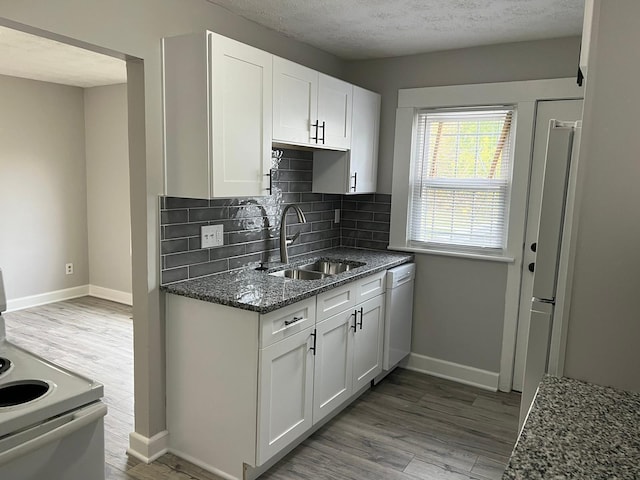 1116-1122 Cole St, Columbus, OH 43205 - kitchen featuring white appliances, light wood-style floors, dark stone counters, and a textured ceiling