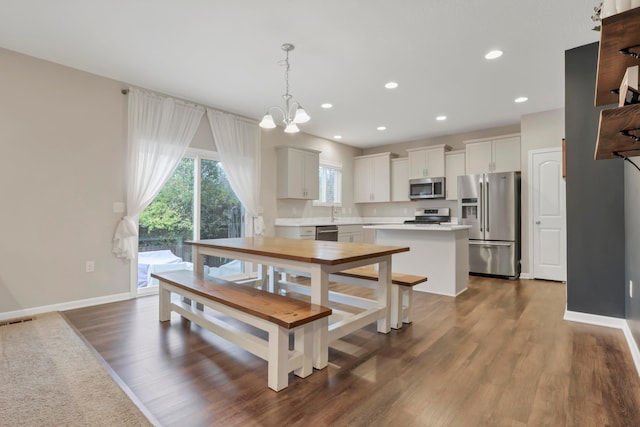 3987 Mad River Rd, Grove City, OH 43123 - dining space featuring dark wood finished floors, a chandelier, and recessed lighting