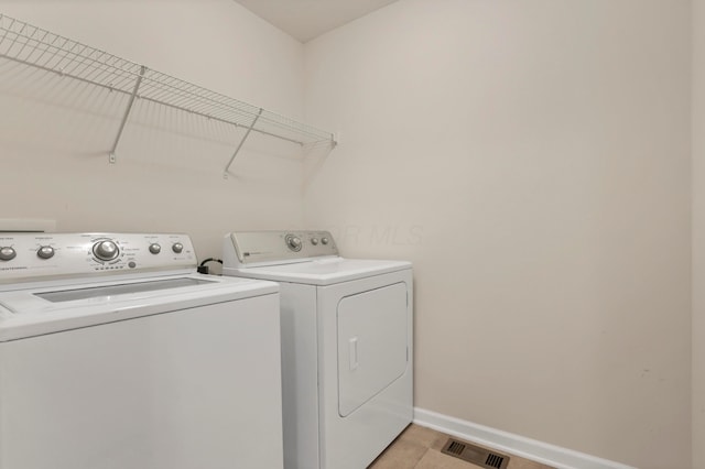3987 Mad River Rd, Grove City, OH 43123 - laundry room with separate washer and dryer and light tile patterned flooring