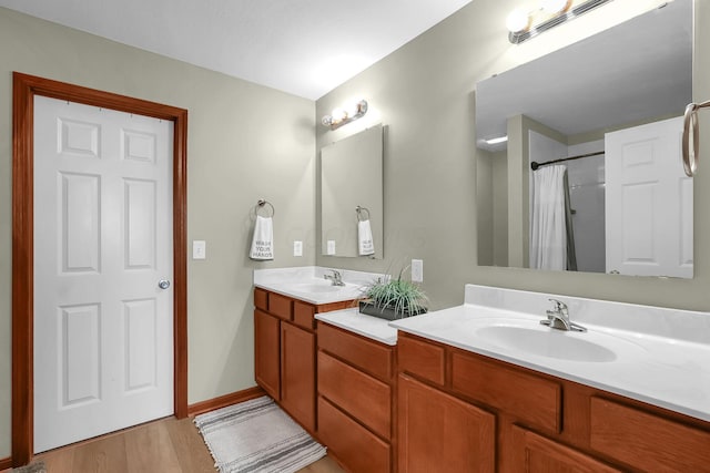 2110 Pickerington Rd, Carroll, OH 43112 - bathroom with double vanity, wood finished floors, and a shower with shower curtain