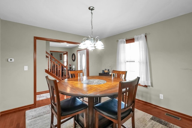 2110 Pickerington Rd, Carroll, OH 43112 - dining room with stairway, a chandelier, and wood finished floors