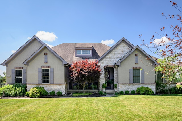 8150 Concord Rd, Delaware, OH 43015 - view of front of house featuring stone siding, a front yard, stucco siding, and a shingled roof