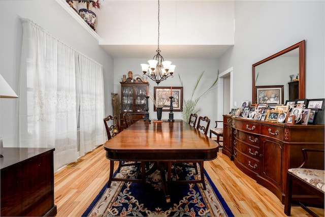 8150 Concord Rd, Delaware, OH 43015 - dining room featuring a chandelier, light wood-type flooring, and a high ceiling