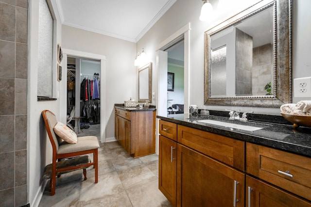 8150 Concord Rd, Delaware, OH 43015 - bathroom featuring crown molding, two vanities, and a walk in closet