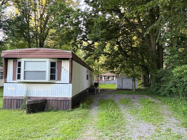 407 Marion St Unit 403, Mcguffey, OH 45859 - view of side of home with a storage shed and driveway