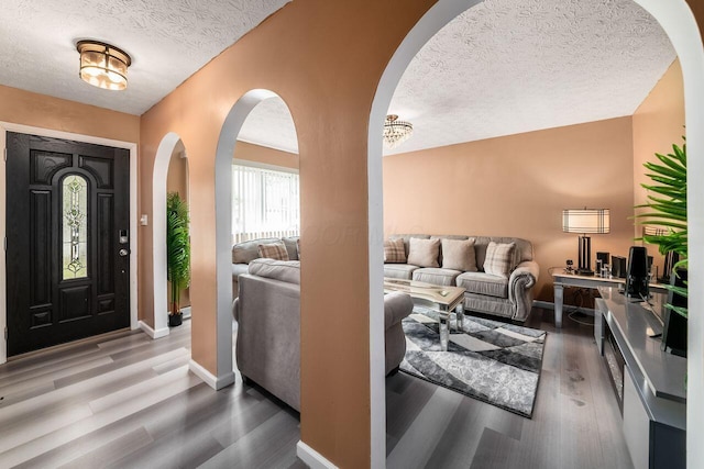 1914 Walden Dr, Columbus, OH 43229 - foyer with arched walkways, a textured ceiling, and wood finished floors