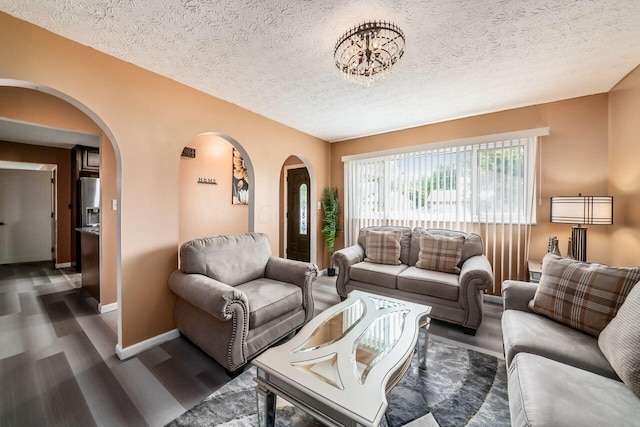 1914 Walden Dr, Columbus, OH 43229 - living room featuring arched walkways, dark wood-style floors, and a textured ceiling