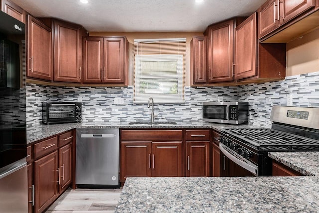 1914 Walden Dr, Columbus, OH 43229 - kitchen with stainless steel appliances, stone counters, light wood-type flooring, tasteful backsplash, and recessed lighting