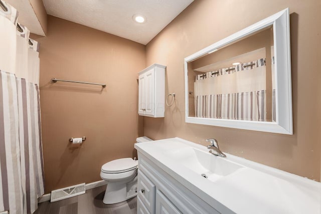 1914 Walden Dr, Columbus, OH 43229 - full bath with vanity, wood finished floors, a textured ceiling, and a shower with curtain