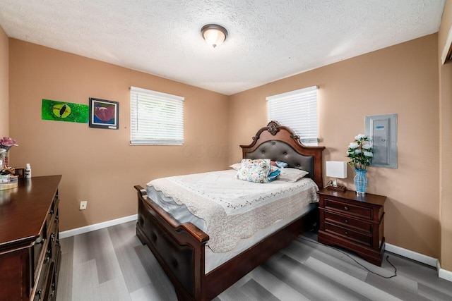 1914 Walden Dr, Columbus, OH 43229 - bedroom with wood finished floors, a textured ceiling, and electric panel