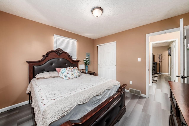 1914 Walden Dr, Columbus, OH 43229 - bedroom featuring wood finished floors, a closet, and a textured ceiling
