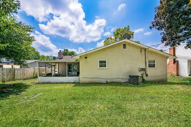 1914 Walden Dr, Columbus, OH 43229 - rear view of house with a sunroom, stucco siding, and a chimney