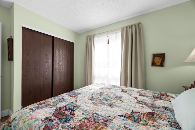 579 Buckeye Ln, Mount Gilead, OH 43338 - bedroom with a closet, a textured ceiling, and carpet floors