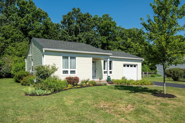 579 Buckeye Ln, Mount Gilead, OH 43338 - view of front facade with an attached garage, a front lawn, driveway, and roof with shingles