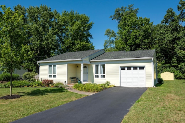 579 Buckeye Ln, Mount Gilead, OH 43338 - ranch-style home with a garage, driveway, a front yard, and a shingled roof