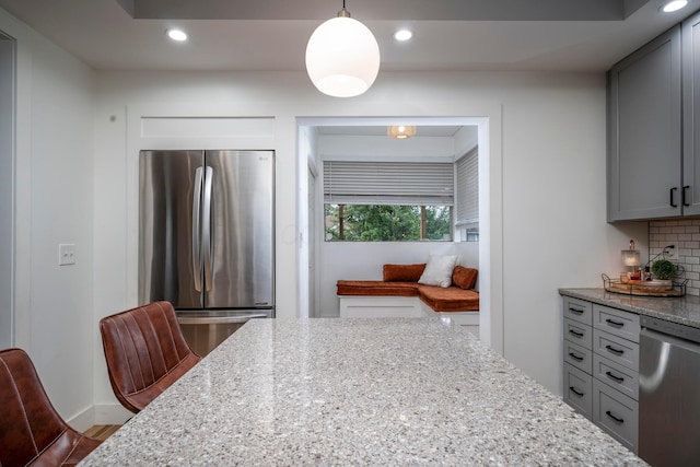 619 Columbus Ave, Washington Court House, OH 43160 - kitchen featuring appliances with stainless steel finishes, light stone countertops, tasteful backsplash, recessed lighting, and gray cabinetry