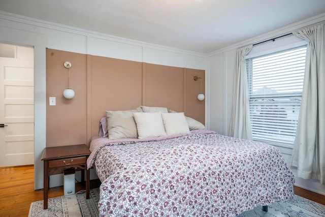 619 Columbus Ave, Washington Court House, OH 43160 - bedroom with wood finished floors and a decorative wall