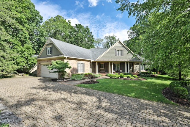 580 Keyes Ln, Worthington, OH 43085 - view of front of home featuring a porch, a front yard, decorative driveway, brick siding, and an attached garage