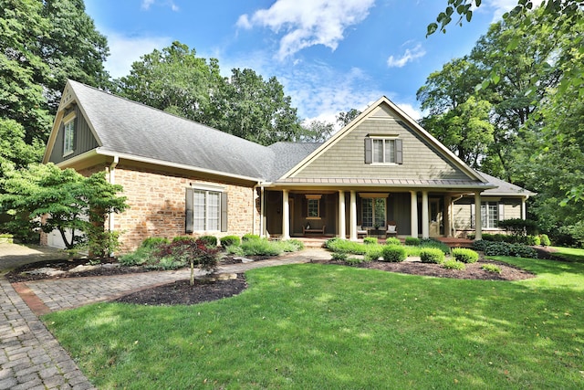580 Keyes Ln, Worthington, OH 43085 - view of front of home featuring a porch, a front lawn, brick siding, and a shingled roof