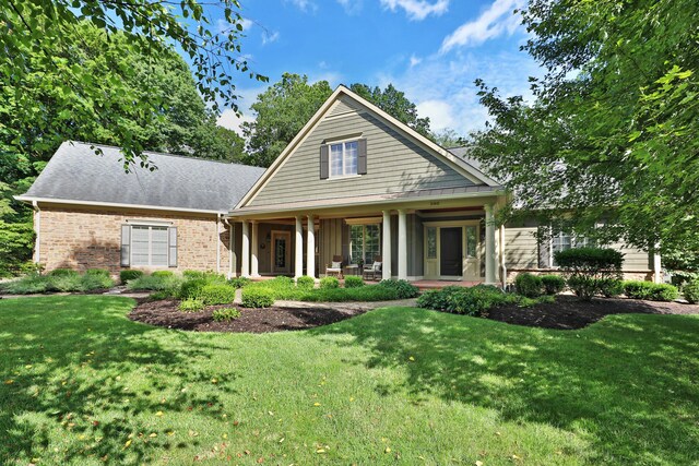 580 Keyes Ln, Worthington, OH 43085 - view of front facade with a front yard, covered porch, and brick siding