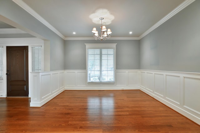 580 Keyes Ln, Worthington, OH 43085 - unfurnished room with a chandelier, wood finished floors, wainscoting, recessed lighting, and crown molding