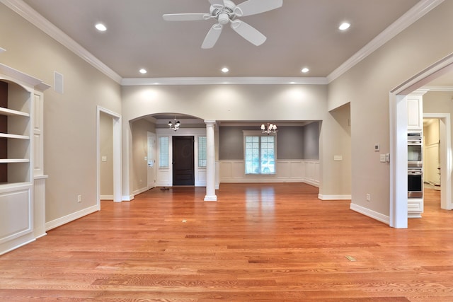 580 Keyes Ln, Worthington, OH 43085 - unfurnished living room featuring ornate columns, a ceiling fan, arched walkways, a chandelier, and crown molding