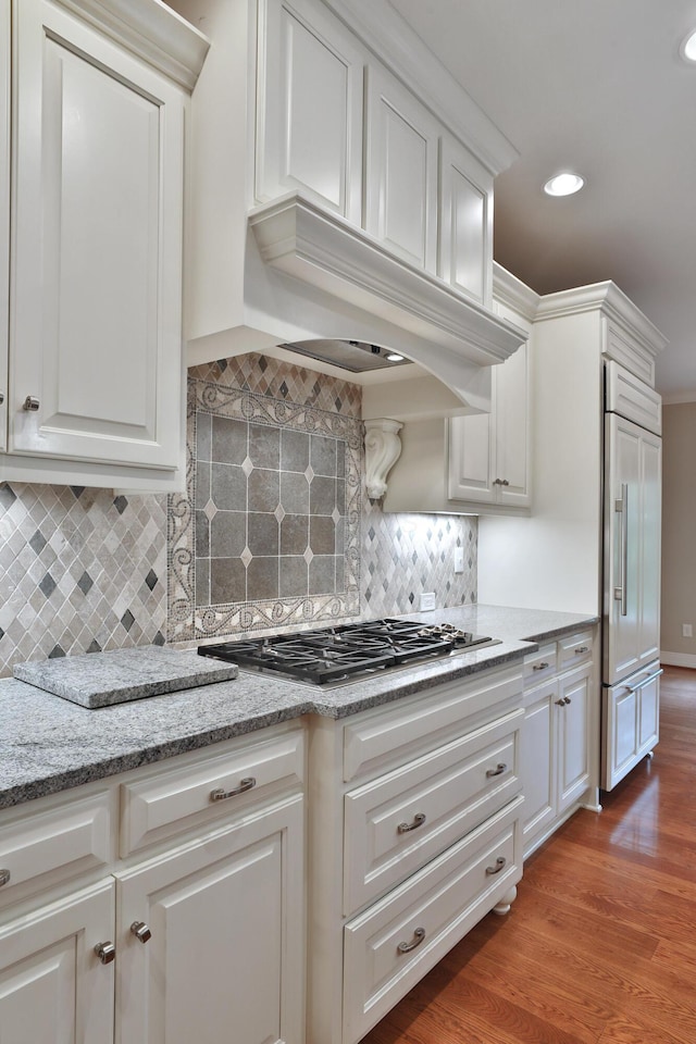 580 Keyes Ln, Worthington, OH 43085 - kitchen featuring paneled built in refrigerator, stainless steel gas stovetop, white cabinetry, recessed lighting, and wood finished floors