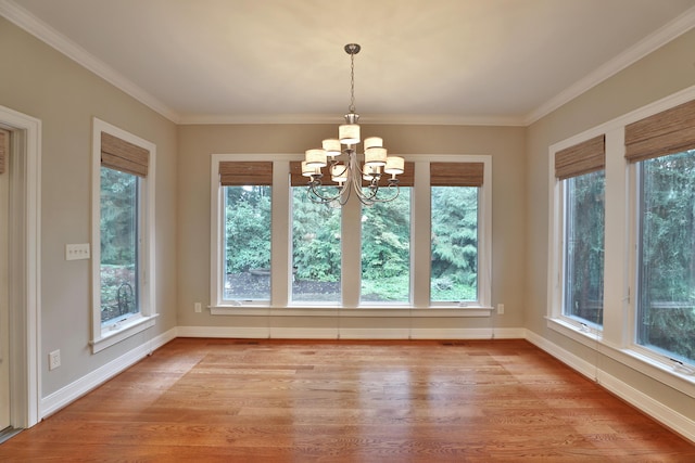 580 Keyes Ln, Worthington, OH 43085 - unfurnished dining area with light wood-style flooring, plenty of natural light, a chandelier, and crown molding