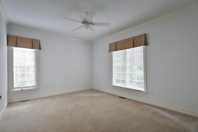 580 Keyes Ln, Worthington, OH 43085 - spare room with crown molding, light carpet, and a ceiling fan