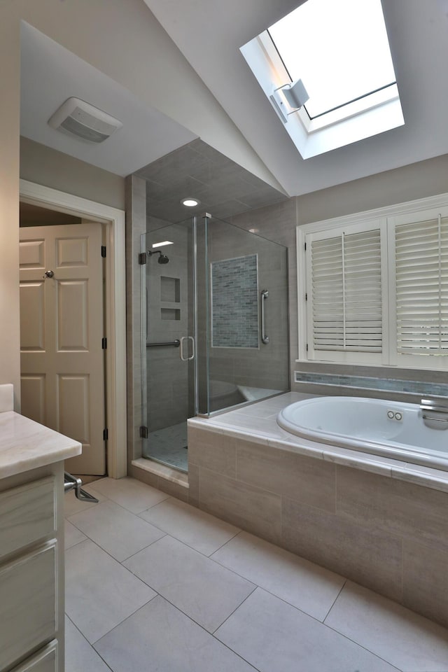 580 Keyes Ln, Worthington, OH 43085 - full bath with a skylight, a garden tub, a stall shower, tile patterned flooring, and vanity