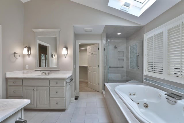 580 Keyes Ln, Worthington, OH 43085 - bathroom with a skylight, lofted ceiling, a stall shower, a jetted tub, and vanity