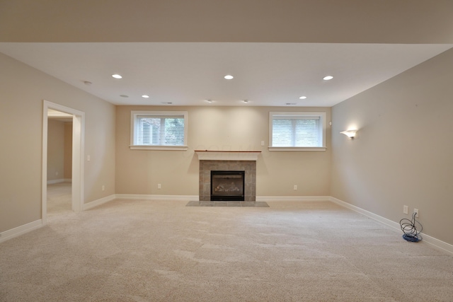 580 Keyes Ln, Worthington, OH 43085 - unfurnished living room with a tiled fireplace, light carpet, and recessed lighting