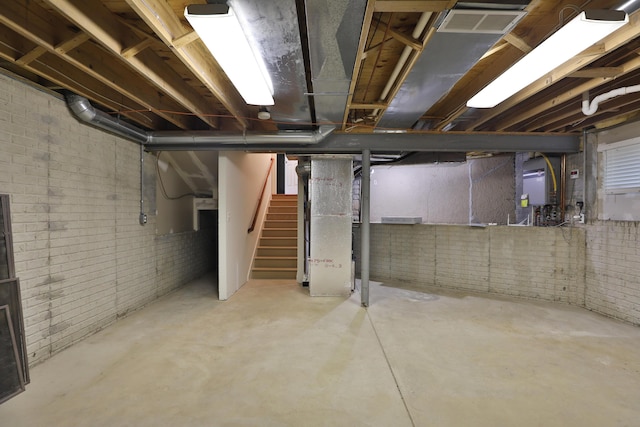 580 Keyes Ln, Worthington, OH 43085 - unfinished below grade area featuring stairway, brick wall, and heating unit