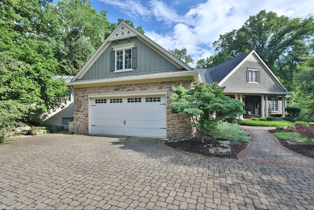 580 Keyes Ln, Worthington, OH 43085 - view of front facade with board and batten siding, decorative driveway, and stone siding