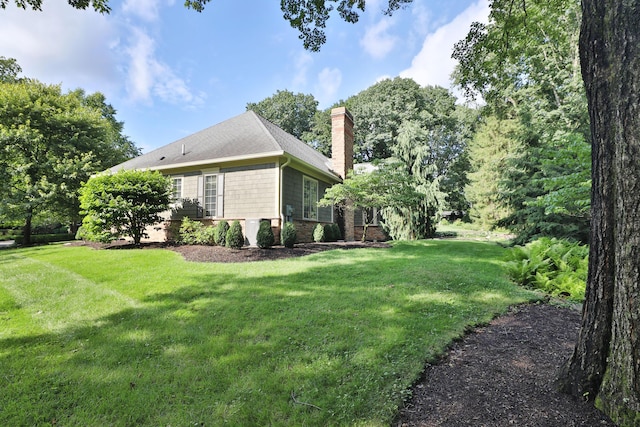 580 Keyes Ln, Worthington, OH 43085 - view of property exterior with a lawn and a chimney